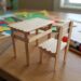 # A Small School Table and Chair Made of Wooden Sticks Making a small school table and chair from wooden sticks is a simple, creative, and educational craft project for children. With a few wooden craft sticks, glue, cardboard, paper, and some imagination, it is possible to create a miniature classroom scene. This project is especially interesting because it transforms simple materials into familiar objects that children see every day at school. The finished table and chair can be used as part of a miniature classroom, dollhouse, school project, or creative display. A miniature school table and chair made from wooden sticks can also introduce children to basic ideas about construction, measurement, balance, design, and organization. While the project looks like a small craft, it requires planning and careful assembly. Children learn that even a simple piece of furniture needs a strong structure to remain stable. ## Understanding the Project A school table and chair are important pieces of classroom furniture. Students use tables for writing, reading, drawing, and completing school activities. Chairs allow them to sit comfortably while learning. Creating miniature versions of these objects gives children an opportunity to understand how furniture is constructed. Wooden craft sticks are especially useful because they are lightweight, easy to arrange, and strong enough for small models. The project can be adapted to different ages. Younger children can make a basic table and chair with adult assistance, while older children can create more detailed models with tabletops, legs, backrests, shelves, and decorations. The finished furniture does not need to be perfectly realistic. The main purpose is to encourage creativity and teach children how different pieces can be joined together to create a stable structure. ## Materials Needed The main material for the project is wooden craft sticks. These can be ordinary flat wooden sticks or slightly thicker craft sticks. The number needed depends on the size and design of the model. Other materials include strong craft glue, cardboard, a ruler, a pencil, scissors, paper, markers, and paint. Cardboard can be used as a base to make the furniture more stable. Small pieces of ribbon, colored paper, stickers, or foam can be used for decoration. If children want to create a complete miniature classroom, additional materials can include bottle caps, cardboard boxes, paper, and recycled packaging. It is useful to prepare all materials before construction begins. Keeping everything nearby makes the activity easier and more organized. ## Planning the Design Planning is an important part of building miniature furniture. Before gluing the wooden sticks together, children should decide how the table and chair will look. A simple drawing can show the tabletop, legs, and supports. Another drawing can show the chair seat, legs, and backrest. The proportions should be considered carefully. The chair should be smaller than the table, and the table should be wide enough to look comfortable for a miniature student. Using a ruler helps children create pieces that are similar in length. Accurate measurements can make the final model more balanced. ## Making the Tabletop The tabletop is usually the first part of the miniature table to build. Several wooden sticks can be placed next to each other horizontally to form a flat surface. Small wooden sticks can be glued across the underside as supports. These supports hold the main sticks together and prevent them from moving apart. The tabletop should be allowed to dry before the legs are attached. If the glue is still wet, the sticks may move out of position. For a different design, cardboard can be used as the tabletop and covered with wooden sticks. This can provide additional strength and make construction easier. ## Building the Table Legs The legs are responsible for supporting the tabletop. Four wooden sticks can be used as legs, one near each corner. The sticks should be attached vertically or at a slight angle, depending on the desired design. It is important to make sure that the legs are approximately the same length. Unequal legs can cause the table to wobble. Small horizontal supports can be added between the legs. These supports strengthen the structure and make the miniature table more realistic. The table should be placed on a flat surface during construction so that the legs can be adjusted before the glue dries. ## Adding Table Supports Real tables often contain supporting structures beneath the tabletop. A miniature table can include small wooden sticks connecting the legs. These supports can form a rectangle underneath the tabletop. They make the model stronger and demonstrate how structural support works. Children can observe that a table is not simply a flat surface with legs. Different parts work together to distribute weight and keep the furniture stable. This is a simple introduction to engineering concepts. ## Making the Chair Seat The chair can be made in a similar way. Several wooden sticks can be arranged side by side to create the seat. Two or more sticks can be placed underneath as supports. The seat should be smaller than the tabletop. Its size should also match the height of the miniature table. A cardboard seat can be used if children find it difficult to connect many wooden sticks. Wooden sticks can then be placed over the cardboard to create a natural wooden appearance. ## Building the Chair Legs Four wooden sticks can form the chair legs. They should be attached underneath the seat. The legs must be positioned carefully so that the chair can stand without falling. Additional horizontal supports can be placed between the legs. These supports make the chair stronger and can also give it a more realistic appearance. Children should test the chair on a flat surface before continuing. If it leans to one side, one of the legs may need to be repositioned. ## Creating the Chair Backrest A school chair usually has a backrest, and adding one makes the miniature model look more complete. Several wooden sticks can be placed vertically or horizontally to create the backrest. Two longer sticks can serve as side supports. The backrest should be attached securely to the back of the seat. Children can experiment with different patterns. For example, they can create a simple solid backrest or arrange the sticks in a decorative pattern. ## Decorating the Furniture Once the table and chair are structurally complete, children can decorate them. The wooden sticks can be left natural for a simple wooden appearance. They can also be painted in bright colors. A school table might be painted blue, green, yellow, or another favorite color. The chair can match the table or have a contrasting color. Small drawings or patterns can be added using markers. Children can also place a tiny paper book, pencil, or notebook on the table. Decorations should be added after the glue has completely dried. ## Creating a Miniature Classroom The small table and chair can become part of a larger classroom model. A cardboard box can serve as the classroom walls. Children can create several tables and chairs for miniature students. A teacher's desk, blackboard, bookshelf, classroom door, and windows can also be added. A small piece of black or dark-colored cardboard can become a chalkboard. Tiny pieces of paper can represent books and classroom posters. This larger project allows children to imagine what happens inside a classroom and how different objects are organized. ## Adding Miniature Students Tiny students can be made from paper, cardboard, modeling clay, or other craft materials. They can be placed on the chairs around the tables. Some can appear to be writing, while others can be reading or raising their hands. Adding students makes the classroom scene more lively. Children can also create a miniature teacher and place the figure near the teacher's desk. This can lead to storytelling activities in which children imagine a lesson taking place inside their handmade classroom. ## Educational Benefits The wooden-stick school furniture project provides many educational benefits. It develops creativity because children must imagine how simple sticks can become recognizable objects. It also improves fine motor skills. Picking up small sticks, applying glue, positioning pieces, and decorating the furniture require careful hand movements. The activity develops patience as well. Glue needs time to dry, and some parts may need to be adjusted before the model is finished. Children also practice problem-solving. If the table is unstable, they need to determine why and find a solution. ## Learning About Measurement The project provides a natural way to practice measurement. Children can measure the lengths of wooden sticks and compare the sizes of the table and chair. They can learn about concepts such as height, width, length, symmetry, and proportion. For older students, the project can become a simple mathematics activity. They might calculate how many sticks are needed or determine the difference between the height of the table and chair. This demonstrates how mathematics can be used in practical situations. ## Learning About Balance and Structure The project also introduces basic engineering concepts. A table must have a stable base, and its legs need to be positioned correctly. The same principle applies to the chair. If one leg is too short or poorly positioned, the chair may wobble. Children can experiment with different structures and observe which designs are stronger. This type of hands-on learning helps children understand that objects are designed according to practical principles. ## Using Recycled Materials Although wooden craft sticks are the main material, many other parts of the project can be made from recycled items. Old cardboard can become a classroom floor. Packaging can become walls, shelves, or books. Paper scraps can become posters and notebooks. Using recycled materials teaches children that useful craft supplies can often be found around the home. It also encourages environmental responsibility by showing that materials can be reused creatively. ## Working as a Group The project can be completed individually or as a group activity. In a classroom, students can work together to create a complete miniature school. One group can build tables and chairs, another can create the classroom walls, and another can make books, students, and decorations. Working together encourages communication and cooperation. Each student can contribute a different skill, making the final project a shared achievement. ## Common Challenges One common challenge is keeping the wooden sticks in place while the glue dries. Children can use small pieces of tape to temporarily hold them together. Another challenge is creating equal-length legs. Measuring the sticks before construction helps solve this problem. The table or chair may also become too heavy if too much glue or too many materials are used. Using only the necessary amount of material keeps the model light. If the furniture becomes unstable, extra supports can be added underneath. These challenges are valuable because they encourage children to experiment and improve their designs. ## Safety Tips Children should use scissors and craft materials carefully. Young children may need adult assistance when cutting cardboard or using certain types of glue. Glue should be used in a well-ventilated area and according to its instructions. Hot glue guns should only be handled by adults or used under close adult supervision. Wooden sticks should be checked to ensure that they are smooth and free from sharp splinters. A clean work surface makes the project safer and easier to manage. ## Conclusion A small school table and chair made from wooden sticks is a wonderful craft project that combines creativity, education, and simple construction. With a few wooden sticks, glue, cardboard, and decorative materials, children can create miniature furniture that resembles the tables and chairs found in a real classroom. The activity teaches much more than crafting. Children learn about measurement, balance, structure, proportion, organization, and problem-solving. They also develop fine motor skills and patience as they carefully position and glue each piece. The finished table and chair can stand alone as a miniature display or become part of a larger school model. Children can add a blackboard, teacher's desk, books, students, shelves, and other classroom objects to create a complete miniature learning environment. Perhaps the most valuable lesson is that simple materials can be transformed through creativity. A collection of ordinary wooden sticks can become useful-looking furniture when the pieces are carefully planned and assembled. This encourages children to look at everyday materials in new ways. Whether made at home, in a classroom, or as part of a school exhibition, a wooden-stick school table and chair provide an enjoyable hands-on experience. The project combines art with practical learning and gives children the satisfaction of creating something with their own hands. In the end, the tiny table and chair are not only attractive handmade objects but also examples of creativity, patience, teamwork, and simple engineering.